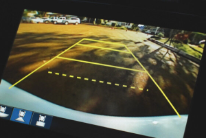 A view of a backup camera feed, present inside of a vehicle at a dealership near Parsons, KS. 