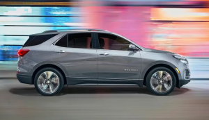 A 2024 Chevrolet Equinox driving quickly down a city street near Parsons, KS