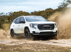 A white 2024 GMC Terrain driving through a muddy road near Parsons, Kansas
